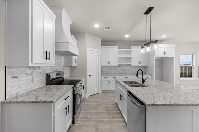 4405 Baylor St, Fort Worth, TX 76119 - kitchen featuring stainless steel appliances, a sink, open shelves, white cabinets, and recessed lighting