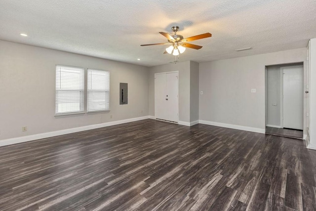 229 S Heartz Rd, Coppell, TX 75019 - unfurnished living room with electric panel, ceiling fan, dark wood finished floors, a textured ceiling, and recessed lighting