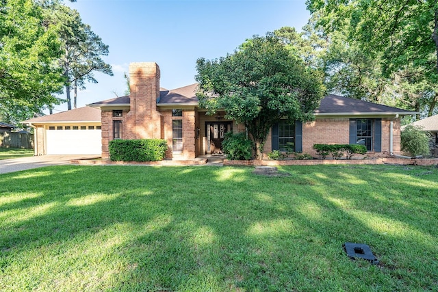17881 Silver Leaf, Flint, TX 75762 - view of front of house featuring an attached garage, concrete driveway, a chimney, and a front yard