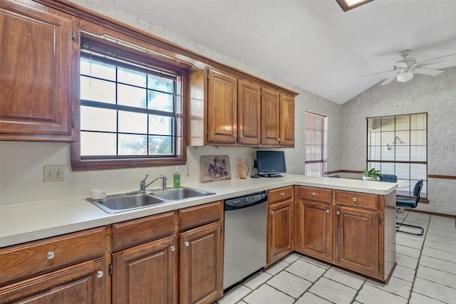 17881 Silver Leaf, Flint, TX 75762 - kitchen with stainless steel dishwasher, vaulted ceiling, a sink, light countertops, and wallpapered walls