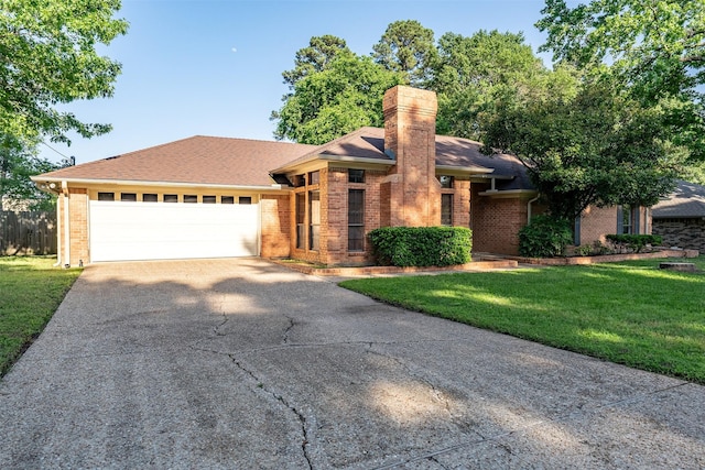 17881 Silver Leaf, Flint, TX 75762 - view of front of home with brick siding, driveway, an attached garage, and a front lawn