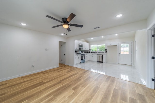 2612 Canary Cir, Mesquite, TX 75149 - unfurnished living room with baseboards, recessed lighting, ceiling fan, and light wood-style floors