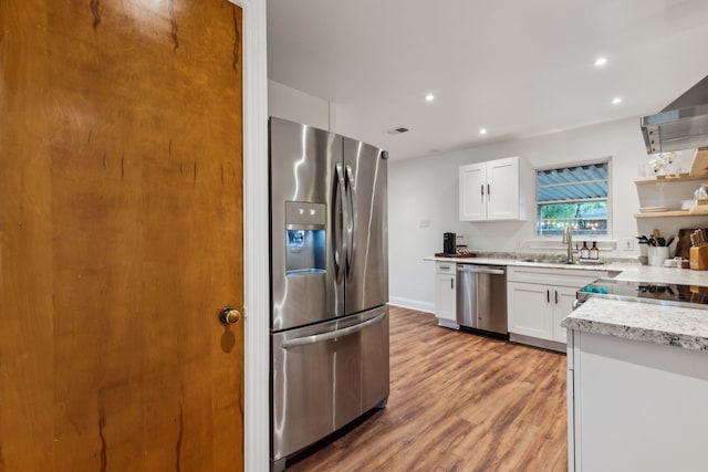 3351 Santa Teresa Ave, Dallas, TX 75228 - kitchen featuring stainless steel appliances, a sink, white cabinetry, light wood finished floors, and recessed lighting