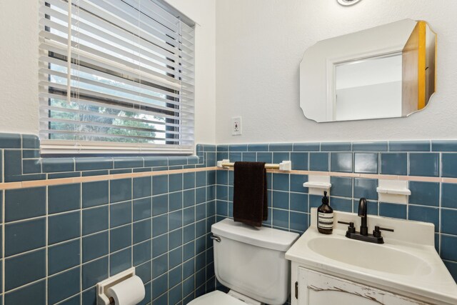 3351 Santa Teresa Ave, Dallas, TX 75228 - bathroom featuring toilet, wainscoting, vanity, and tile walls