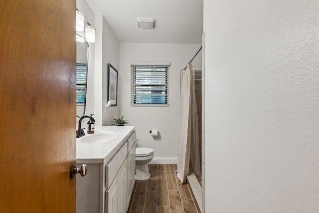 3351 Santa Teresa Ave, Dallas, TX 75228 - bathroom featuring toilet, vanity, wood finished floors, baseboards, and a shower with curtain