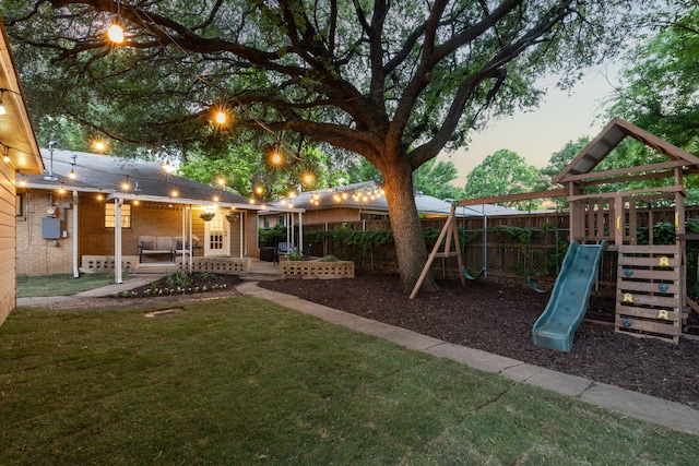 3351 Santa Teresa Ave, Dallas, TX 75228 - yard at dusk featuring a playground and a patio