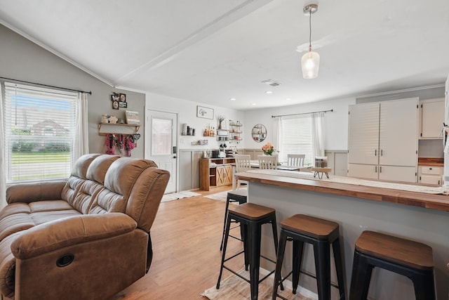 4602 Marlboro Dr, Abilene, TX 79606 - kitchen with a breakfast bar area, wooden counters, open floor plan, white cabinetry, and light wood-style floors