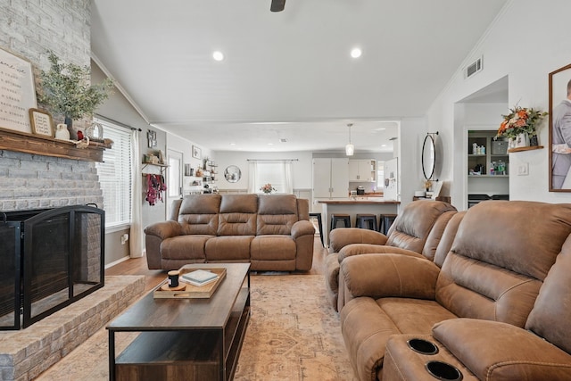 4602 Marlboro Dr, Abilene, TX 79606 - living area featuring a brick fireplace, plenty of natural light, vaulted ceiling, recessed lighting, and light wood-type flooring