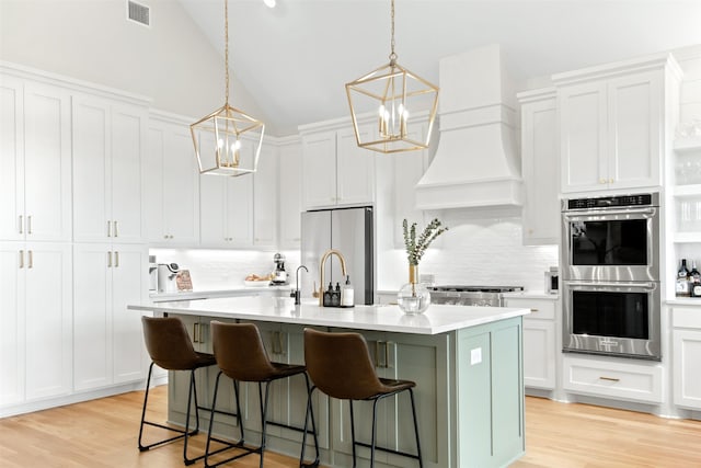 2410 Somercrest Pl, Midlothian, TX 76065 - kitchen with stainless steel appliances, a chandelier, backsplash, light countertops, and vaulted ceiling