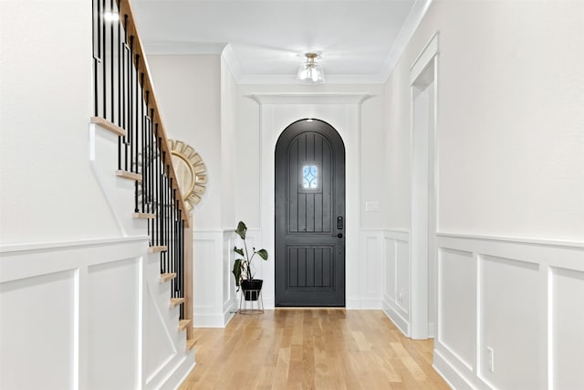 2410 Somercrest Pl, Midlothian, TX 76065 - entrance foyer featuring a decorative wall, stairs, arched walkways, crown molding, and light wood finished floors