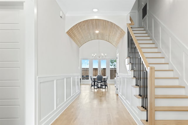 2410 Somercrest Pl, Midlothian, TX 76065 - stairway featuring a decorative wall, a chandelier, wood finished floors, lofted ceiling, and wainscoting