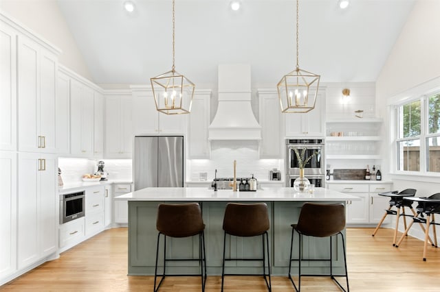 2410 Somercrest Pl, Midlothian, TX 76065 - kitchen with appliances with stainless steel finishes, a chandelier, lofted ceiling, decorative backsplash, and white cabinetry