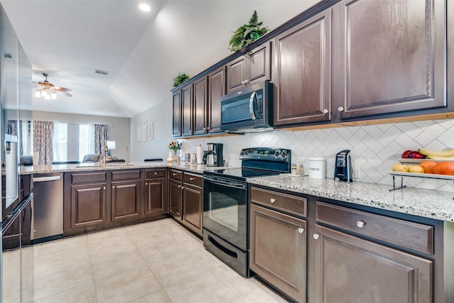 4002 Silver Lake Trl, Heartland, TX 75126 - kitchen featuring stainless steel appliances, decorative backsplash, ceiling fan, dark brown cabinets, and lofted ceiling