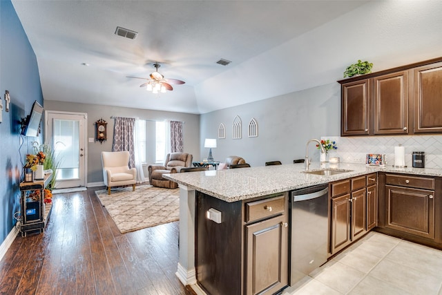 4002 Silver Lake Trl, Heartland, TX 75126 - kitchen featuring dishwasher, a sink, lofted ceiling, a ceiling fan, and light stone countertops