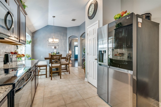 4002 Silver Lake Trl, Heartland, TX 75126 - kitchen featuring stainless steel refrigerator with ice dispenser, black electric range, arched walkways, tasteful backsplash, and a chandelier