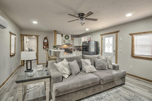 179 Oak St, Nocona, TX 76255 - living room featuring light wood-style floors, ceiling fan, healthy amount of natural light, baseboards, and recessed lighting