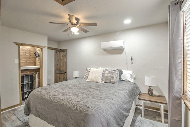 179 Oak St, Nocona, TX 76255 - bedroom featuring a wall mounted air conditioner, wood finished floors, a ceiling fan, recessed lighting, and baseboards