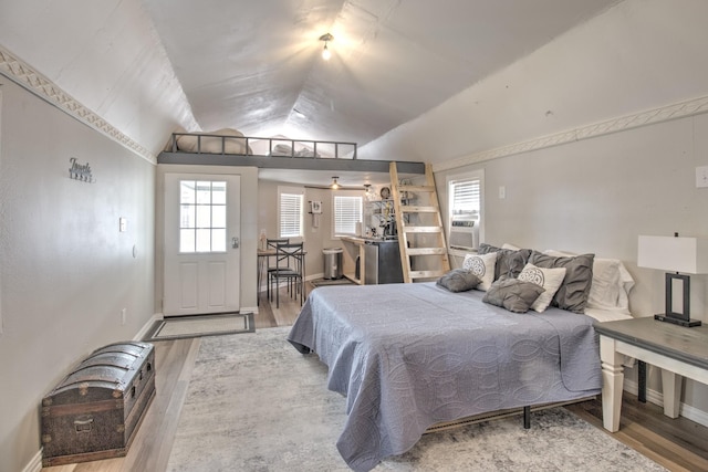 179 Oak St, Nocona, TX 76255 - bedroom featuring wood finished floors, lofted ceiling, and baseboards