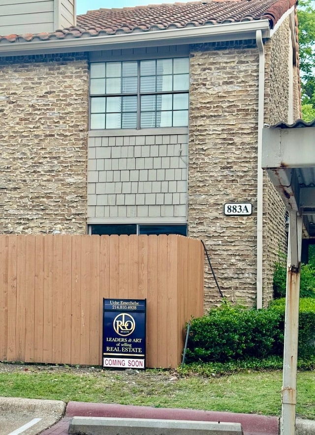 883 Dublin Dr Unit 1, Richardson, TX 75080 - view of home's exterior featuring a tile roof and fence