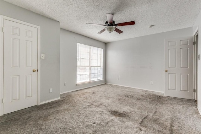 9601 Forest Ln Unit 822, Dallas, TX 75243 - carpeted spare room with a ceiling fan, a textured ceiling, and baseboards