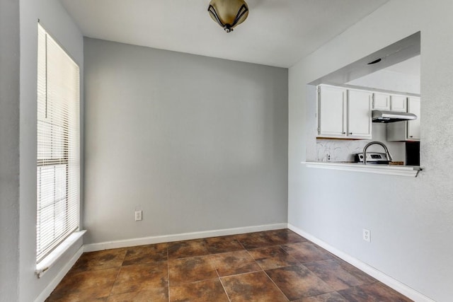 9601 Forest Ln Unit 822, Dallas, TX 75243 - unfurnished dining area with baseboards