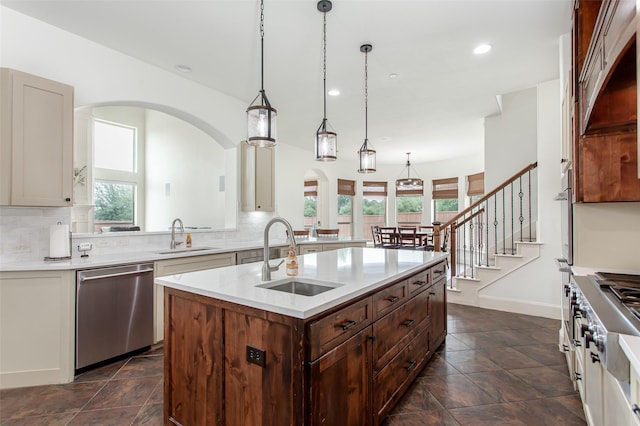 968 Fairfield Ln, Allen, TX 75013 - kitchen featuring appliances with stainless steel finishes, a sink, arched walkways, healthy amount of natural light, and recessed lighting