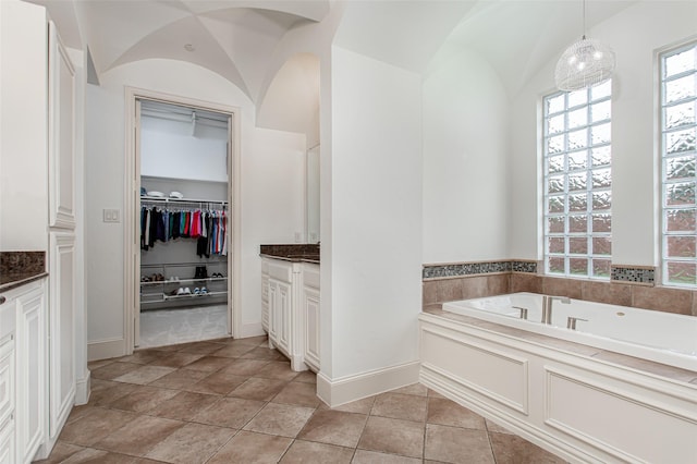 968 Fairfield Ln, Allen, TX 75013 - full bathroom featuring vanity, a garden tub, a spacious closet, and lofted ceiling