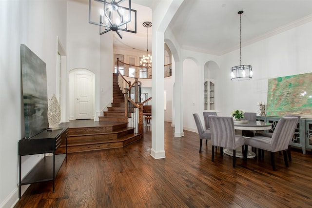 968 Fairfield Ln, Allen, TX 75013 - dining area with a chandelier, arched walkways, stairway, wood finished floors, and crown molding