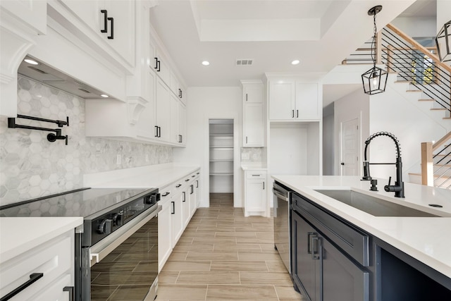 9320 Beckleycrest Ave, Dallas, TX 75232 - kitchen with range with electric cooktop, a sink, light countertops, white cabinets, and recessed lighting
