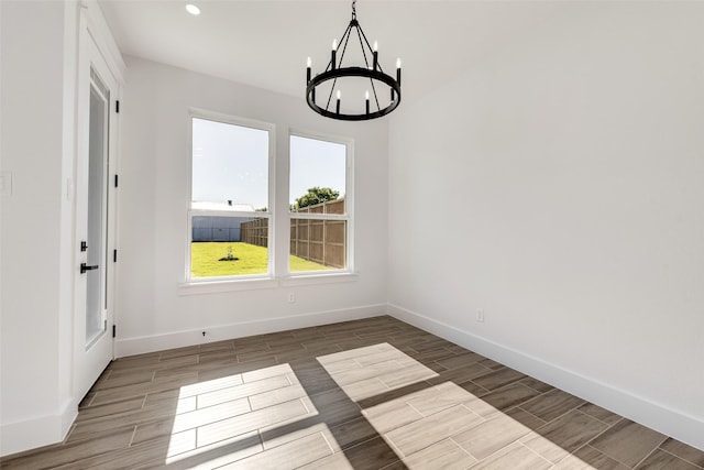 9320 Beckleycrest Ave, Dallas, TX 75232 - unfurnished dining area featuring a chandelier, wood tiled floors, baseboards, and recessed lighting