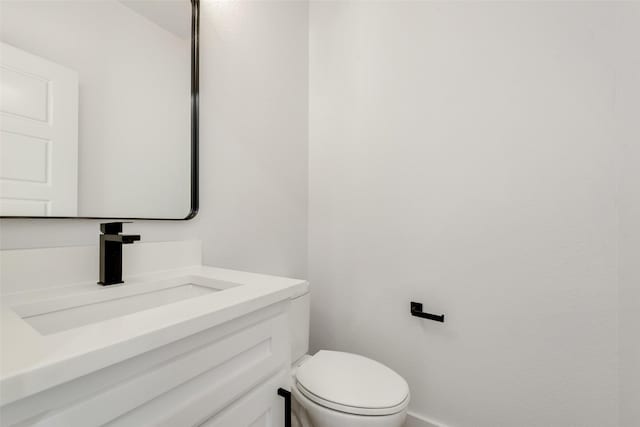 9320 Beckleycrest Ave, Dallas, TX 75232 - half bathroom with vanity, baseboards, and toilet
