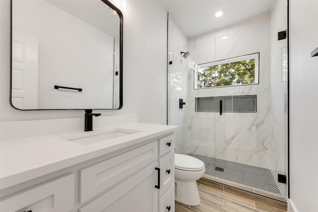 9320 Beckleycrest Ave, Dallas, TX 75232 - bathroom with toilet, a marble finish shower, vanity, wood tiled floors, and recessed lighting