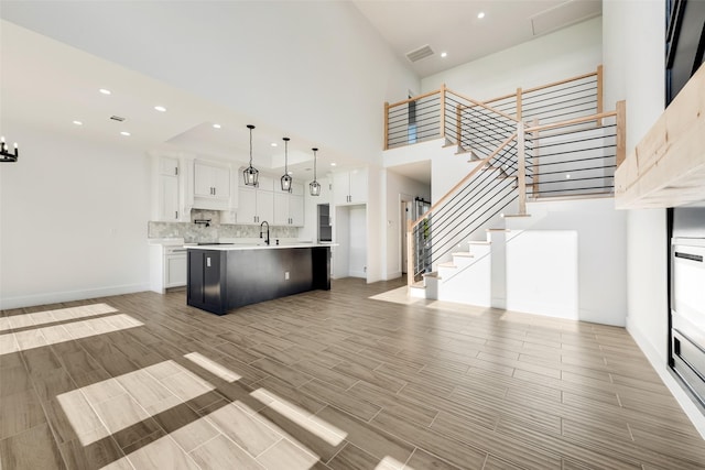 9320 Beckleycrest Ave, Dallas, TX 75232 - kitchen featuring white cabinets, decorative backsplash, light countertops, open floor plan, and recessed lighting