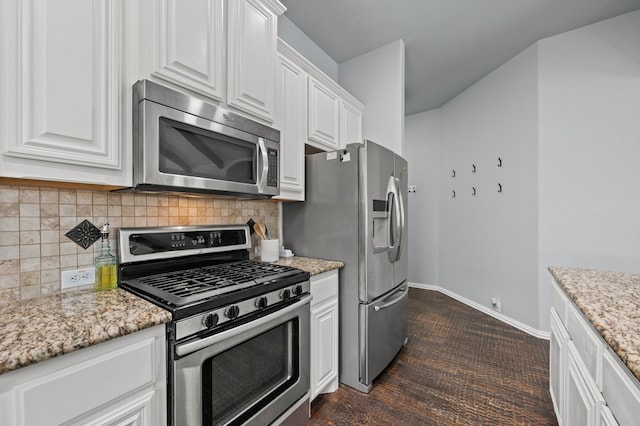 1200 Killian Dr, Mansfield, TX 76063 - kitchen with appliances with stainless steel finishes, white cabinetry, decorative backsplash, light stone counters, and baseboards