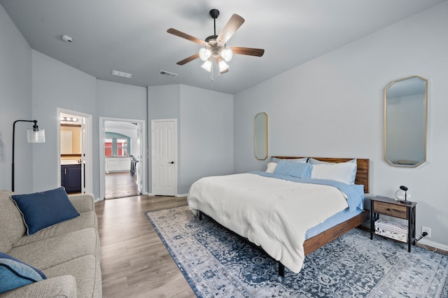 1200 Killian Dr, Mansfield, TX 76063 - bedroom featuring wood finished floors, arched walkways, baseboards, a ceiling fan, and ensuite bathroom