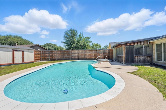 view of swimming pool featuring a shed, a fenced backyard, an outdoor structure, and a patio