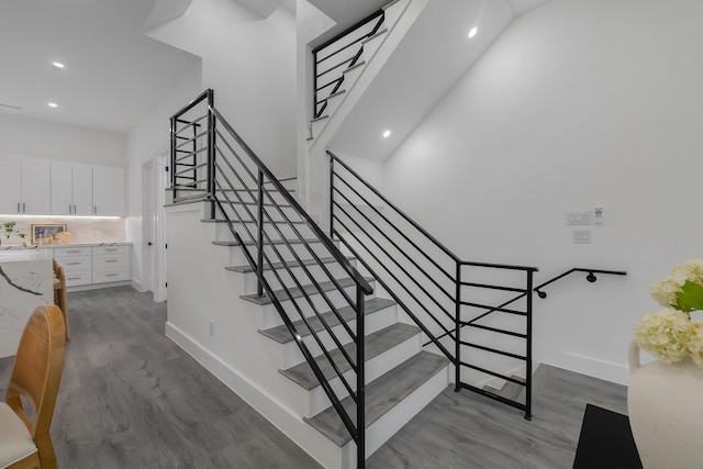 1921 Pollard St, Dallas, TX 75208 - stairs featuring wood finished floors, recessed lighting, and baseboards