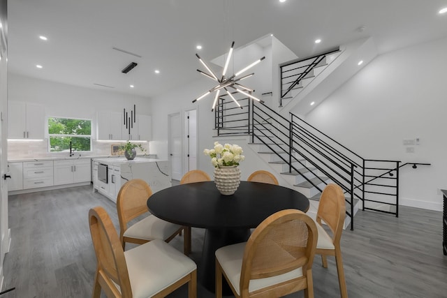 1921 Pollard St, Dallas, TX 75208 - dining room featuring light wood-style flooring, stairway, recessed lighting, a chandelier, and baseboards