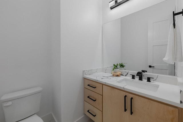 1921 Pollard St, Dallas, TX 75208 - bathroom featuring toilet, vanity, and baseboards