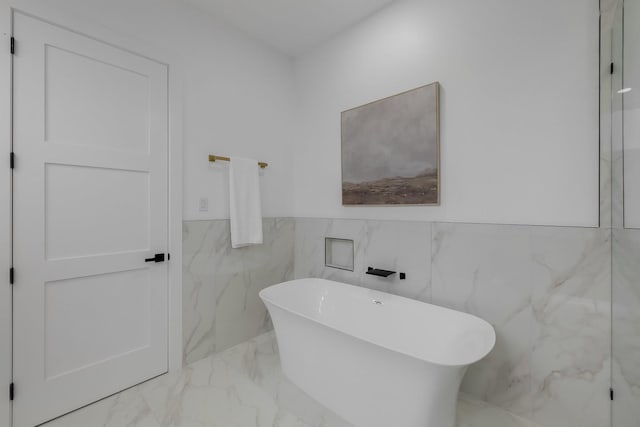 1921 Pollard St, Dallas, TX 75208 - full bath with a freestanding tub, marble tiled floors, and a wainscoted wall