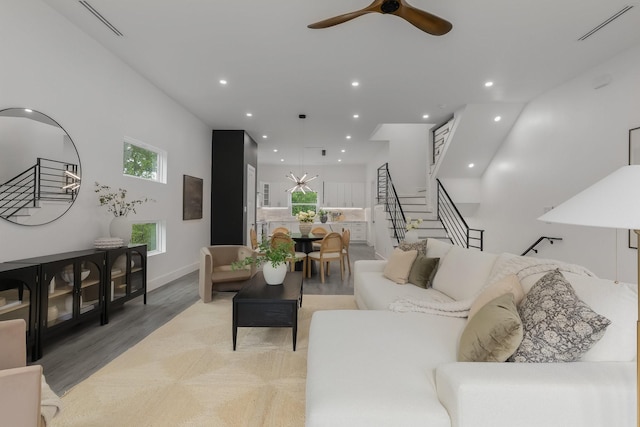 1921 Pollard St, Dallas, TX 75208 - living room with stairs, a ceiling fan, light wood finished floors, and recessed lighting