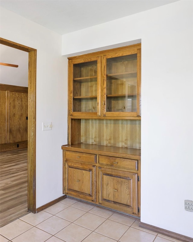 empty room with light tile patterned floors and baseboards