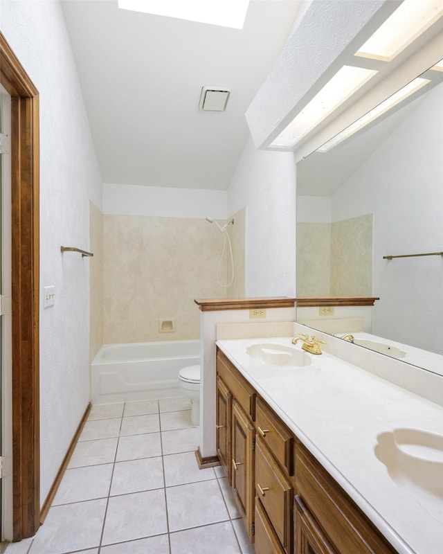 full bath with toilet, tile patterned floors, double vanity, and washtub / shower combination
