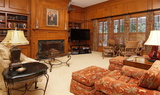 1706 Kiowa, Graham, TX 76450 - carpeted living room with a fireplace, built in features, ornamental molding, and wooden walls