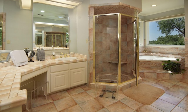 1706 Kiowa, Graham, TX 76450 - full bath featuring ornamental molding, a shower stall, a garden tub, a ceiling fan, and vanity