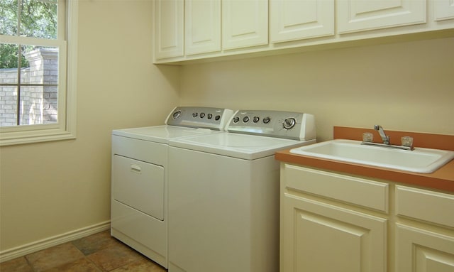 1706 Kiowa, Graham, TX 76450 - clothes washing area with cabinet space, washing machine and dryer, and baseboards
