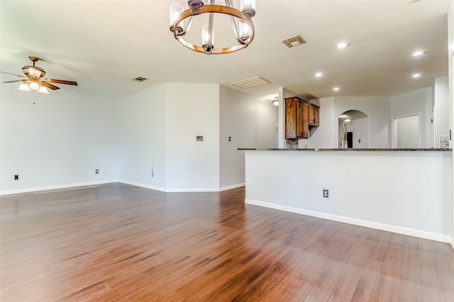 2007 Brazoria Dr, Forney, TX 75126 - unfurnished living room with arched walkways, a ceiling fan, a chandelier, light wood-style floors, and recessed lighting