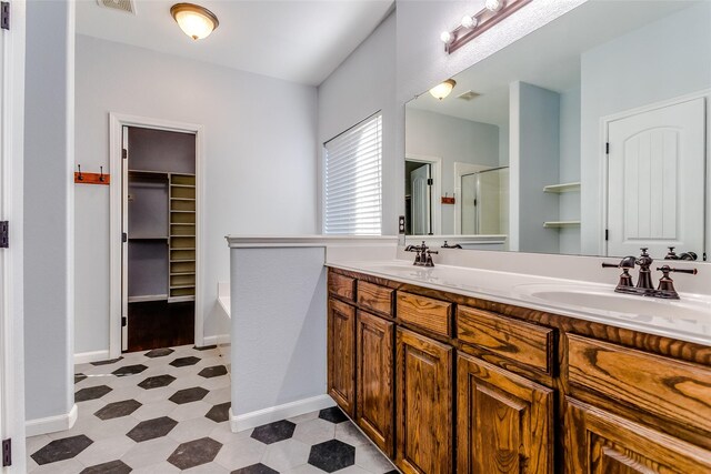 2007 Brazoria Dr, Forney, TX 75126 - full bathroom with a shower stall, tile patterned floors, double vanity, a walk in closet, and a garden tub