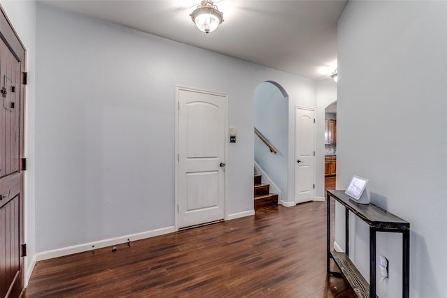 2007 Brazoria Dr, Forney, TX 75126 - entryway with arched walkways, dark wood finished floors, stairway, and baseboards