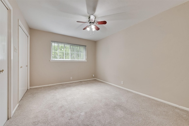 unfurnished bedroom featuring carpet flooring, baseboards, and ceiling fan